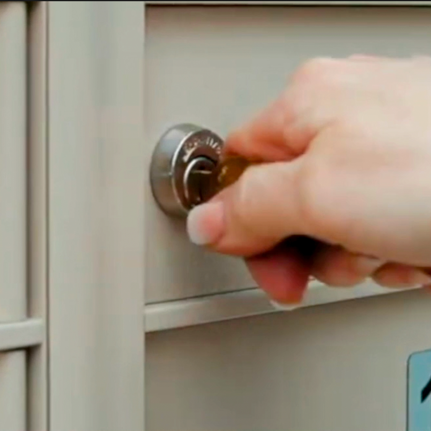 Person Inserting Replacement Mailbox Key Into USPS Cluster Mailbox Lock